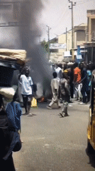 Large crowd gathers on street in Ado, Nigeria