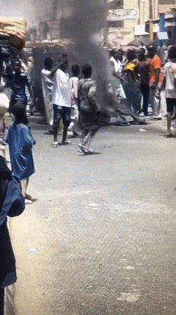Large crowd gathers on street in Ado, Nigeria