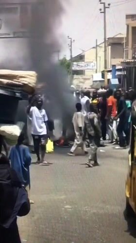 Large crowd gathers on street in Ado, Nigeria