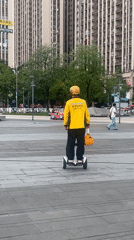 Yellow-clad rider on self-balancing scooter, Chongqing High-tech Zone