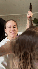 Woman plays with tabby cat at Moscow home