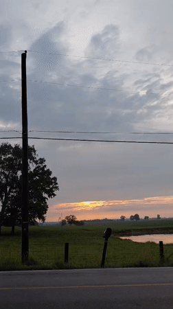 Sunrise over rural Kentucky pastures along a quiet country road