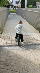 Child cycles through Riedlingen as tractor parks nearby