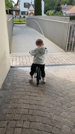 Child cycles through Riedlingen as tractor parks nearby
