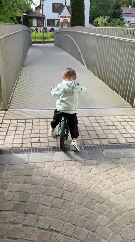 Child cycles through Riedlingen as tractor parks nearby