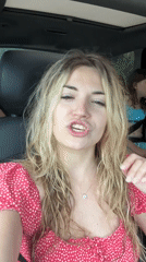 Woman in polka dot dress films car trip in Budva