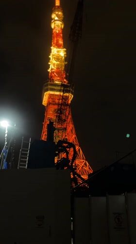 Tokyo Tower construction continues amid rainy morning in Minato