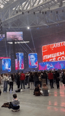Indoor gathering with portrait displays during lilac season in Saint Petersburg