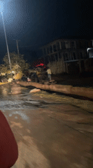 Nighttime motorcycle journey through wet Abuja streets documented