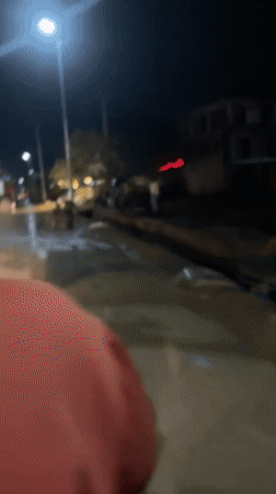 Nighttime motorcycle journey through wet Abuja streets documented
