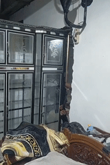 Men move decorative cabinet, reveal wall damage in Lhokseumawe