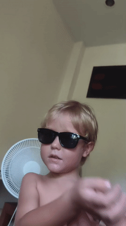 Child in sunglasses photographed in Thailand village
