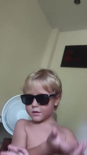 Child in sunglasses photographed in Thailand village
