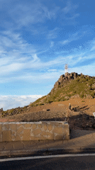 Tourists photograph scenic mountain views in Portugal's Santana region