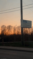 Driver records sunset journey past directional signs near Penza