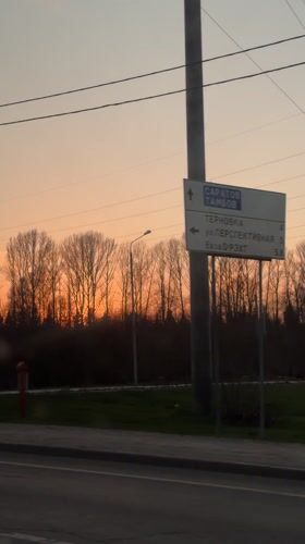 Driver records sunset journey past directional signs near Penza