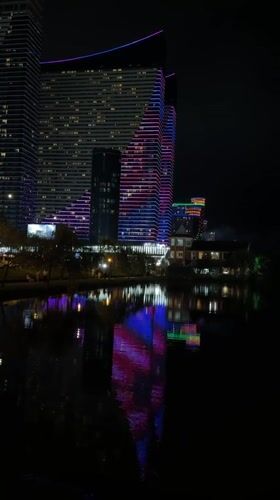 Batumi's illuminated Marriott tower reflected in a still lake