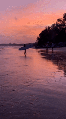 Sunset on Weligama Beach, surfboard in hand