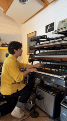 Musician plays four-keyboard stack in Runnymede audio room