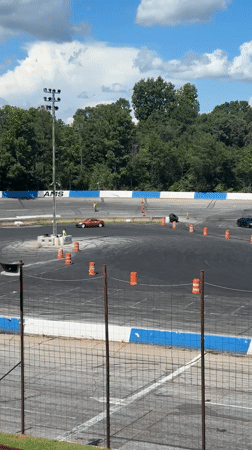 Cars drifting cone courses at a Williamston track event
