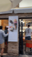 Lively restaurant scene in Sanxenxo with a game on TV