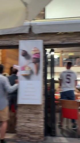 Lively restaurant scene in Sanxenxo with a game on TV