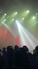 Concert performer takes stage under colorful lights in Buenos Aires