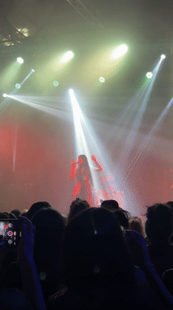 Concert performer takes stage under colorful lights in Buenos Aires