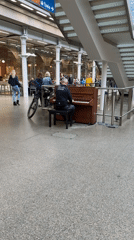 Man plays piano in London public space
