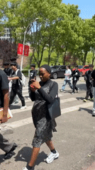 Students and pedestrians gather on sunny Jiangjin street