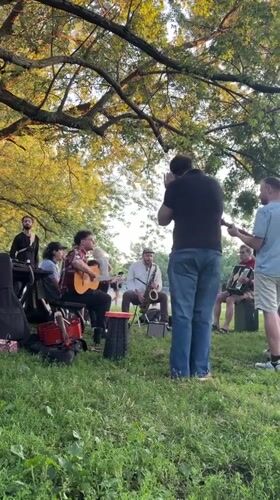 Outdoor musical session under a tree in Montreal