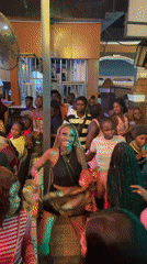 Nightclub scene with live music and dancing in Obosi