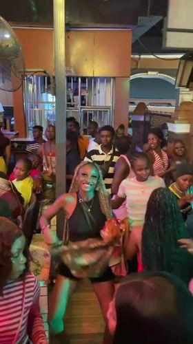 Nightclub scene with live music and dancing in Obosi