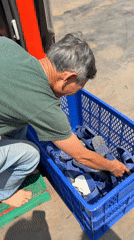 Man handles sandal crate barefoot in Vietnam