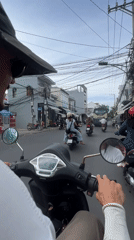 First-person scooter ride through Nha Trang morning traffic