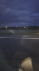 Vehicle passenger films nighttime airfield view in Luxembourg