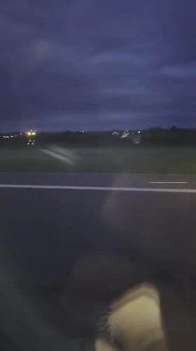Vehicle passenger films nighttime airfield view in Luxembourg
