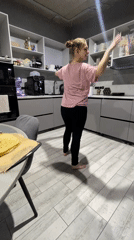 Woman dances barefoot in kitchen in Industrialny, Russia