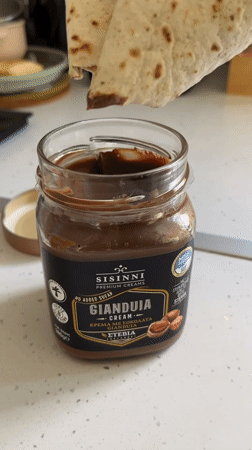 Person prepares chocolate tortilla snack in Limassol kitchen