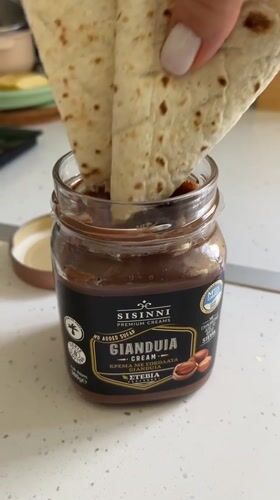 Person prepares chocolate tortilla snack in Limassol kitchen