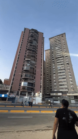 Residential towers line a marked street in Maracay, Venezuela