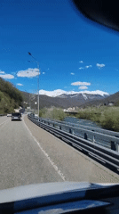 Highway traffic flows through scenic Krasnaya Polyana mountains