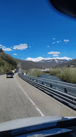 Highway traffic flows through scenic Krasnaya Polyana mountains