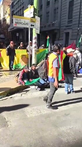 Street demonstration with flags, banner observed in La Paz