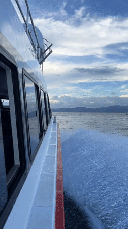 White boat creates wake near Jungutbatu, Indonesia