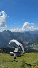Paraglider launches and soars over the Austrian Alps