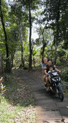 Late-night moped journey through forest path in Indonesia