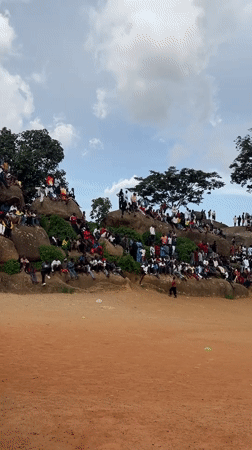 Crowd gathers on Jos rock formations for outdoor event