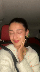 Woman smiles at camera during car ride in Montenegro