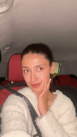 Woman smiles at camera during car ride in Montenegro